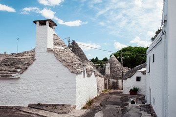 Fototapeta na wymiar Brick houses trulli in Alberobello. Puglia Italy on a sunny day. UNESCO Cultural Heritage List