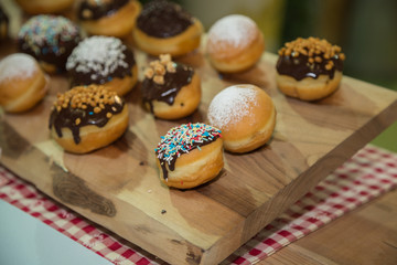 Pastries with icing Sugar and Chocolate Arranged on a Wooden Chopping Board