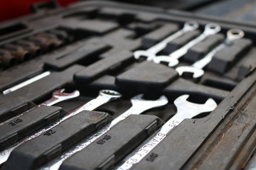 Set of metal automotive repair wrenches up close abstract
