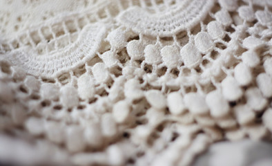 white fabric, consisting of lace, lies neatly