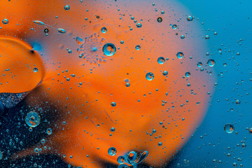 Abstract colorful background with oil drops and waves on water surface