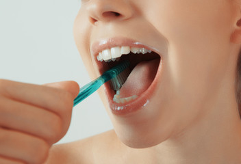 Woman brushes her teeth