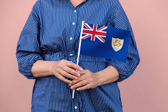  Anguilla flag. Close up of a woman's hands holding Anguilla flag.