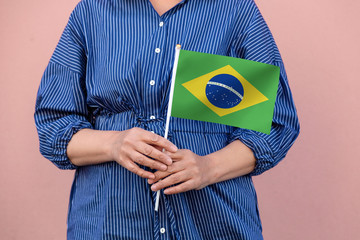 Brazilian flag. Close up of a woman's hands holding Brazil flag.