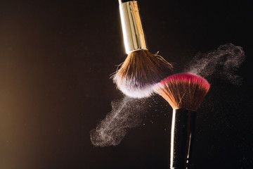 Makeup brush on black background