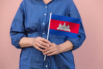 Cambodia flag. Close up of a woman's hands holding Cambodian flag.