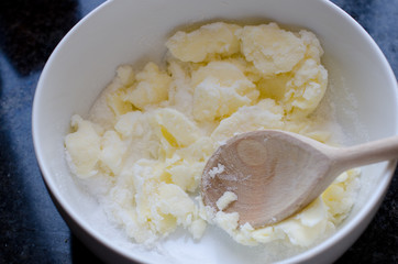 Mixing butter and sugar in bowl