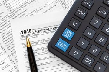 US 1040 Tax Form, pen and calculator