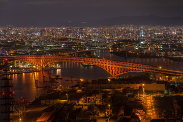 Fototapeta na wymiar Minato Bridge (red bridged) view on Cosmo tower,Osaka Japan