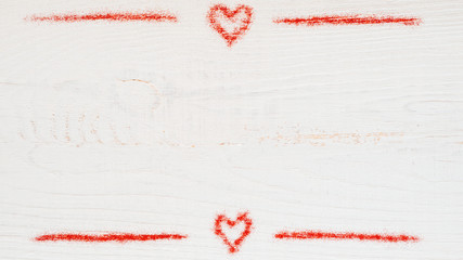 Red glitter on white wooden texture. Valentine's day concept