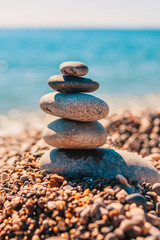 Fototapeta na wymiar Smooth large sea pebbles are stacked on the seashore - Zen Concept