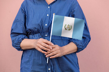 Guatemala flag. Close up of woman's hands holding Guatemalan flag.