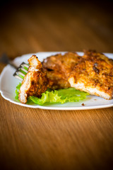 pork fillet chop fried in batter, in a plate