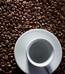 cup of coffee and beans on wooden background