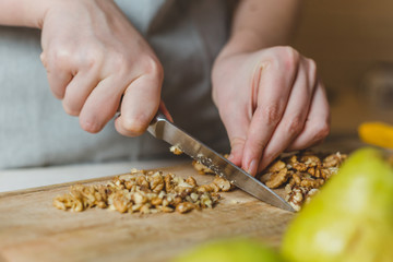 Cutting a walnut into a festive salad - cooking at home