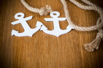 white decorative anchor on a wooden background