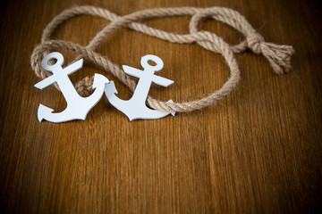 white decorative anchor on a wooden background