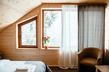 wooden bedroom interior with large window