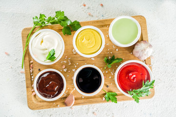 Set of classic sauces on white stone concrete stone background.