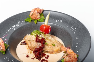fish fillet with sauce baked and decorated