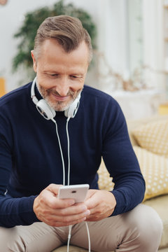 Man with headphones looking at smartphone