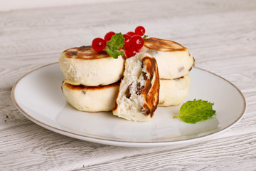 curds fritter on a white dish on a light background