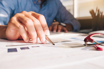 Close up Businessman using calculator and laptop for do math finance on wooden desk in office and business working background, tax, accounting, statistics and analytic research concept - Image