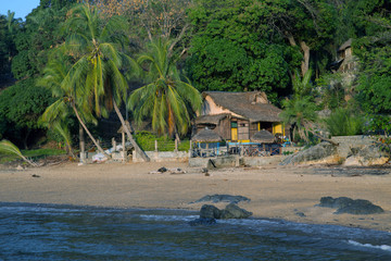 House with a roof of palm leaves on the beach of Nosy Komba island