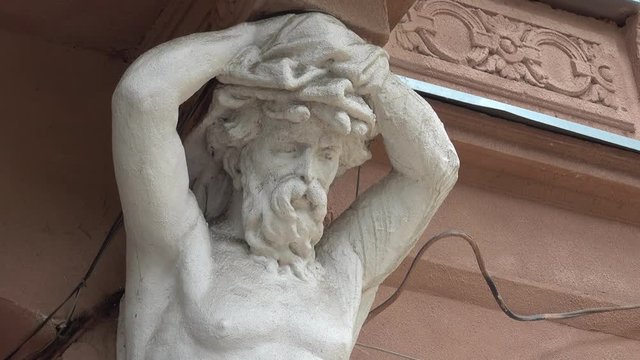 Kherson, Ukraine - 14th of June 2017: 4K Sad Titan holding balcony