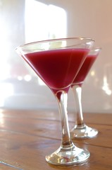 two flutes  of pink cocktail 