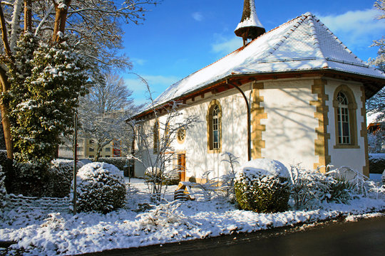 Snow covered old protestant church in Lyss, Switzerland.