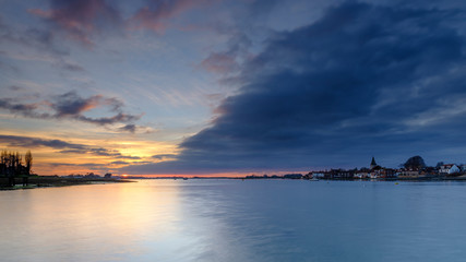 Winter sunset over Bosham harbour and village, West Sussex, UK