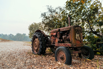 Old tractor on a pebble beach by a river