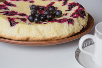 Homemade berry cake on light table. Shallow focus. Soft light