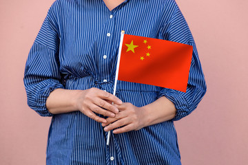 Chinese flag. Close up of a woman's hands holding China flag.	