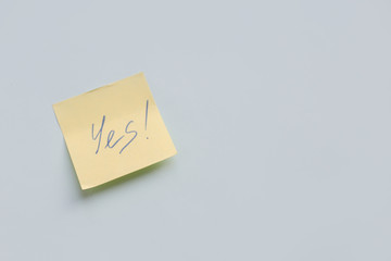 text Yes on yellow paper sticker on the blue background, Success, Goal Concept