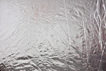 Silver foil shiny metallic texture background wrapping paper for Christmas and winter holiday wallpaper decoration element
