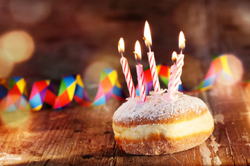 Donut with candles and carnival decoration