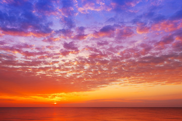 Naklejka na ściany i meble Beautiful, orange-pink sunset over the sea. Background image.