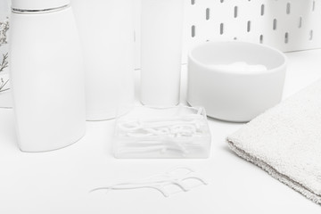 White dental floss stick on bathroom table
