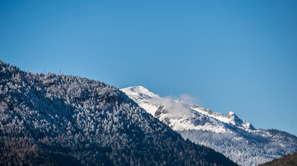 mountain with snow alps with trees and blue sky