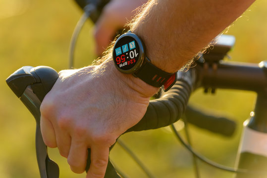 Man riding a bike with smartwatch heart rate monitor