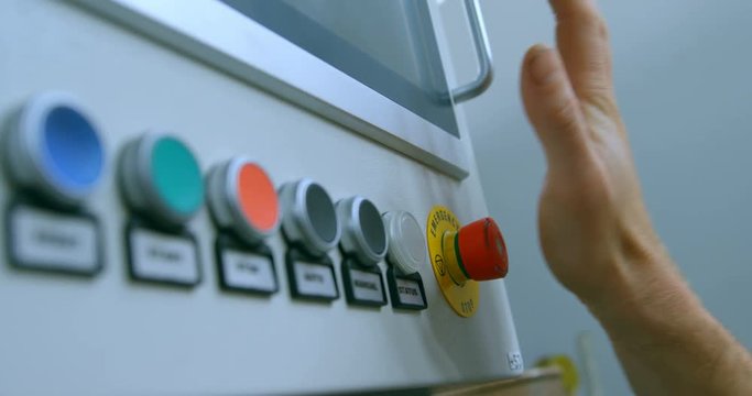 Robotic engineer pushing control panel button