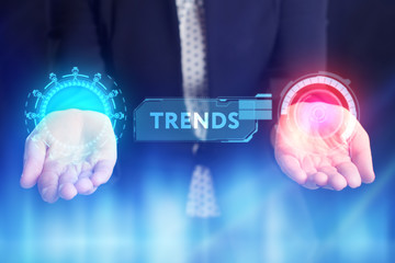 The concept of business, technology, the Internet and the network. A young entrepreneur working on a virtual screen of the future and sees the inscription: Trends