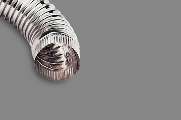 Single chrome corrugated elbow of pipe for air, water, oil or gas on gray background with copy...