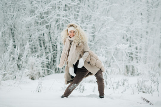 Portrait of blonde woman on walk in winter forest