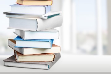 Colorful books collection on background.