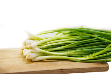 Scallion green onion spring onion salad onion bundle whole root isolated on white background.