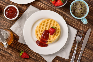 Waffles and jam on breakfast table