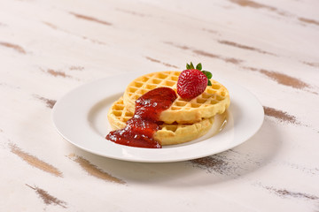 Waffles and jam on breakfast table